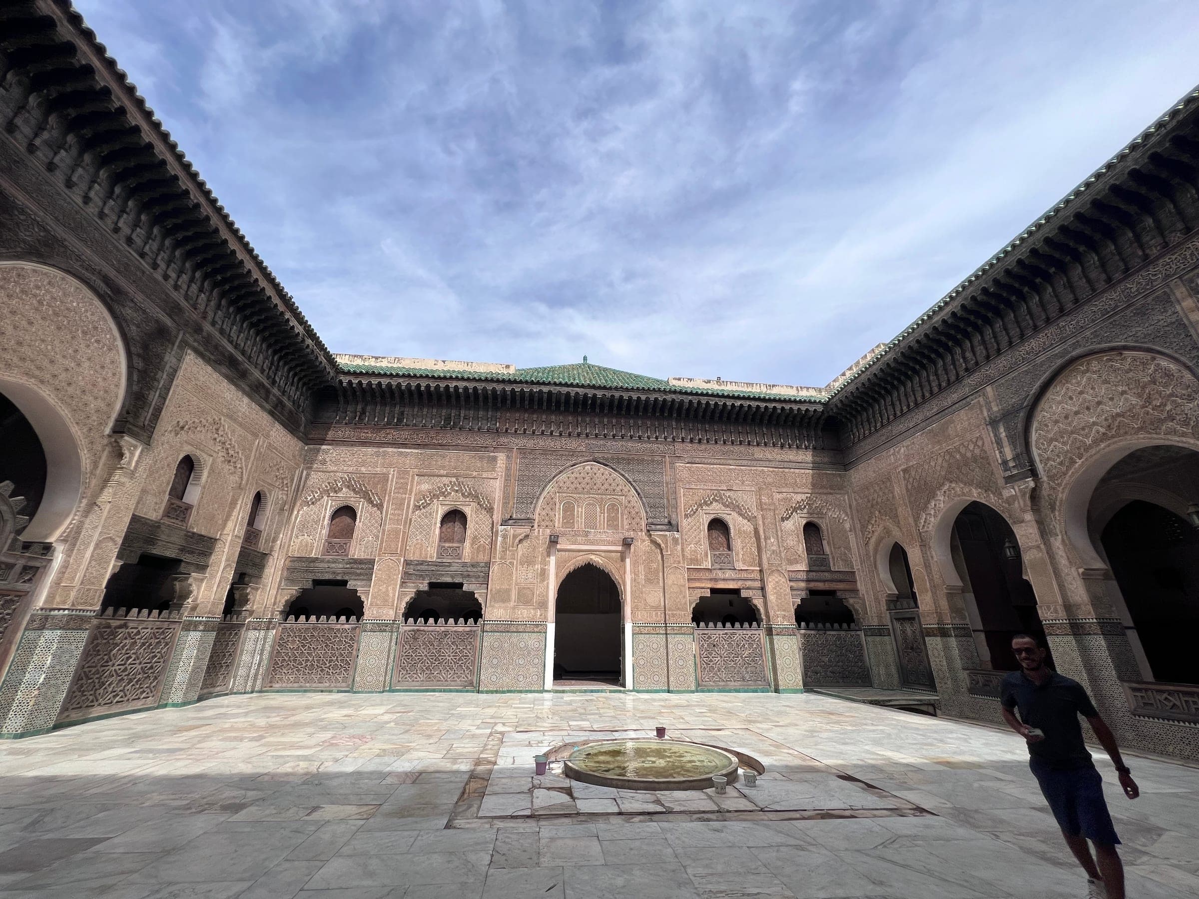 A sunlit courtyard inside a Fez medina madrasa